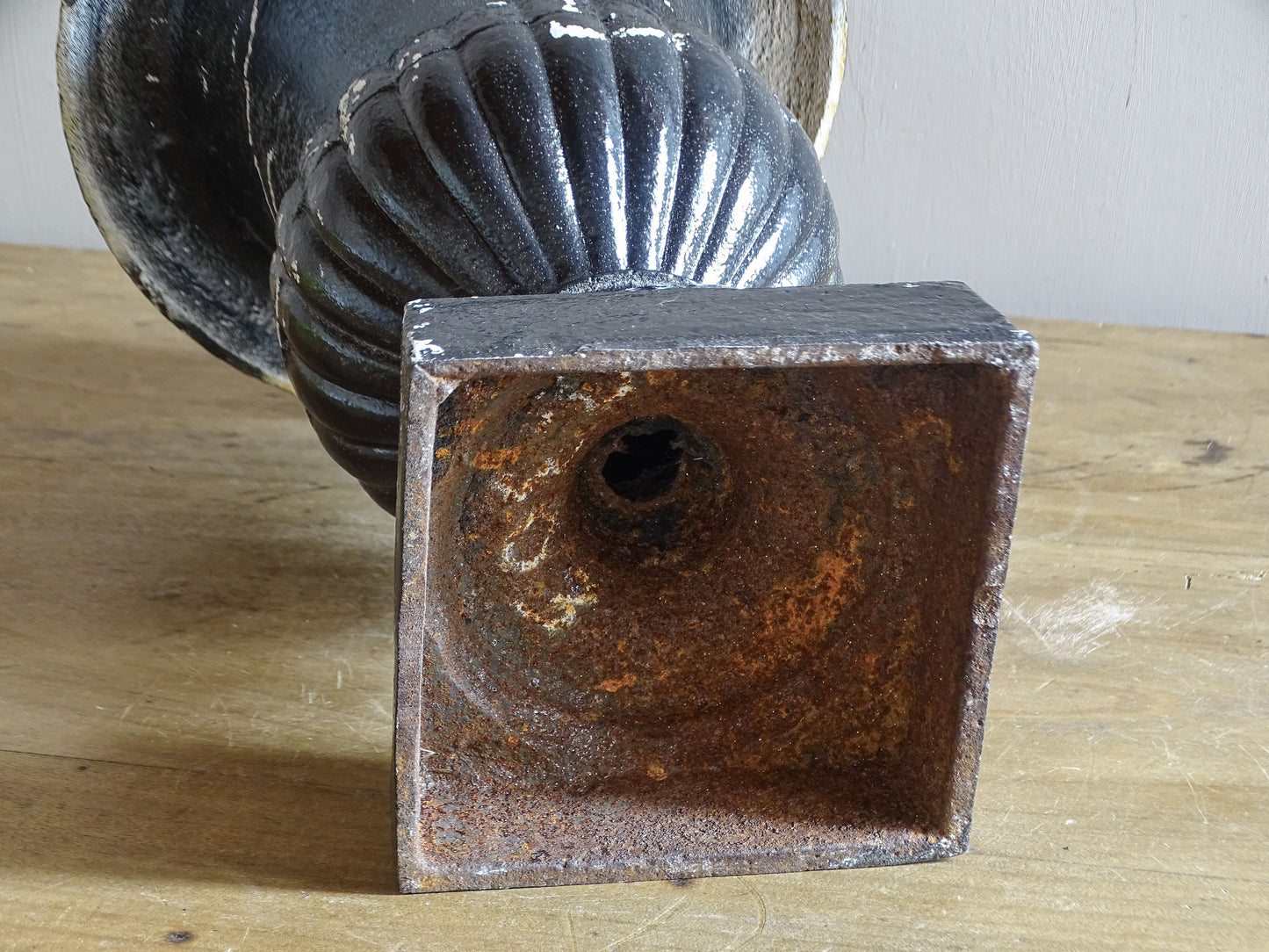 Antique French cast iron Médici urn planter with black painted finish, flared rim, gadrooned detail and square pedestal base.