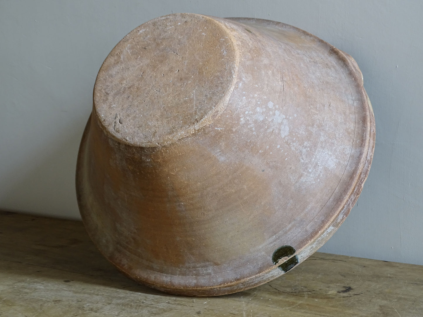 Large antique French tian bowl with dark olive-green glazed interior and unglazed terracotta exterior, early 20th century.