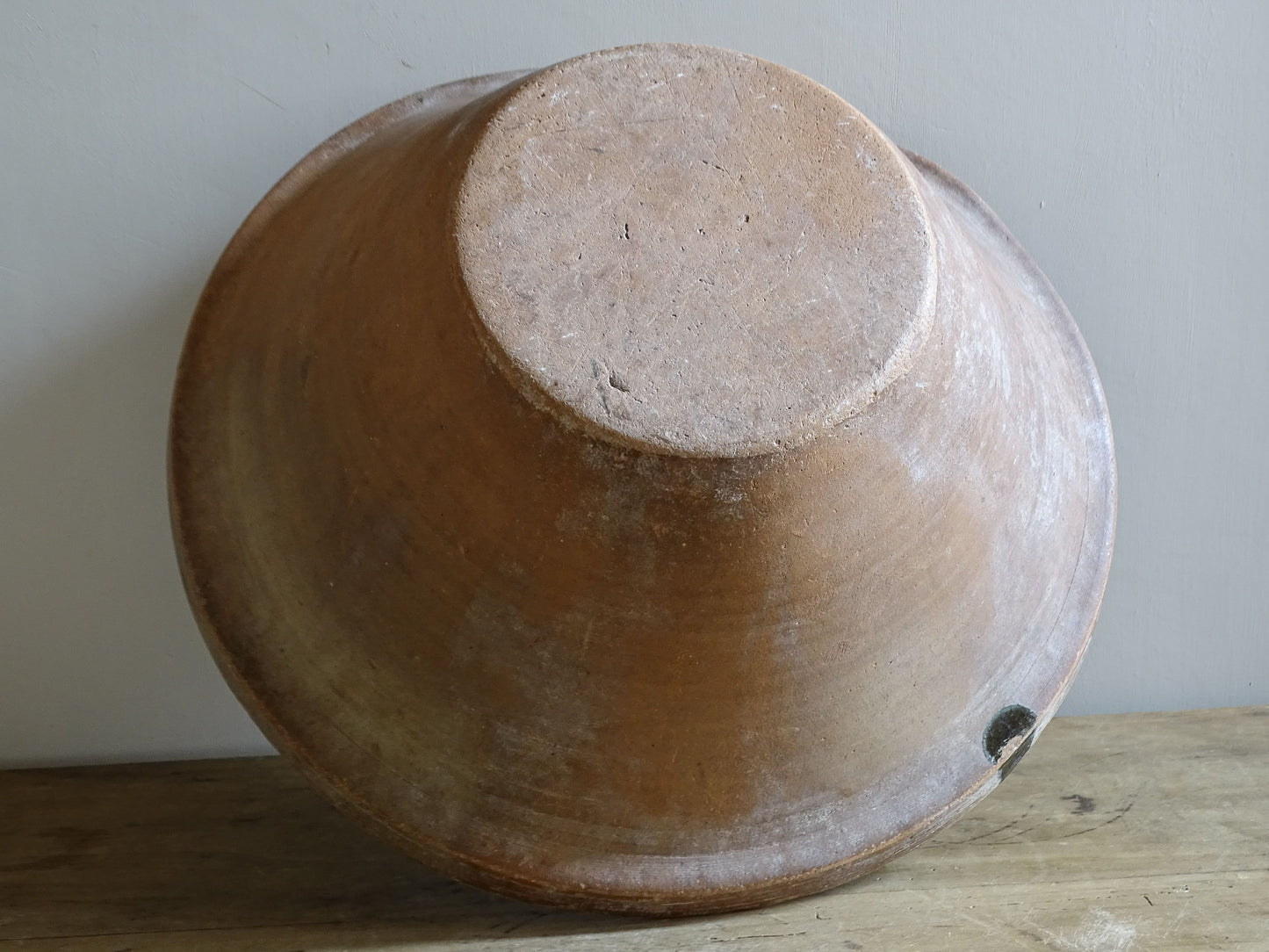 Large antique French tian bowl with dark olive-green glazed interior and unglazed terracotta exterior, early 20th century.