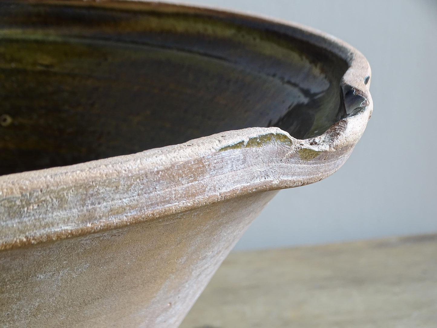 Large antique French tian bowl with dark olive-green glazed interior and unglazed terracotta exterior, early 20th century.