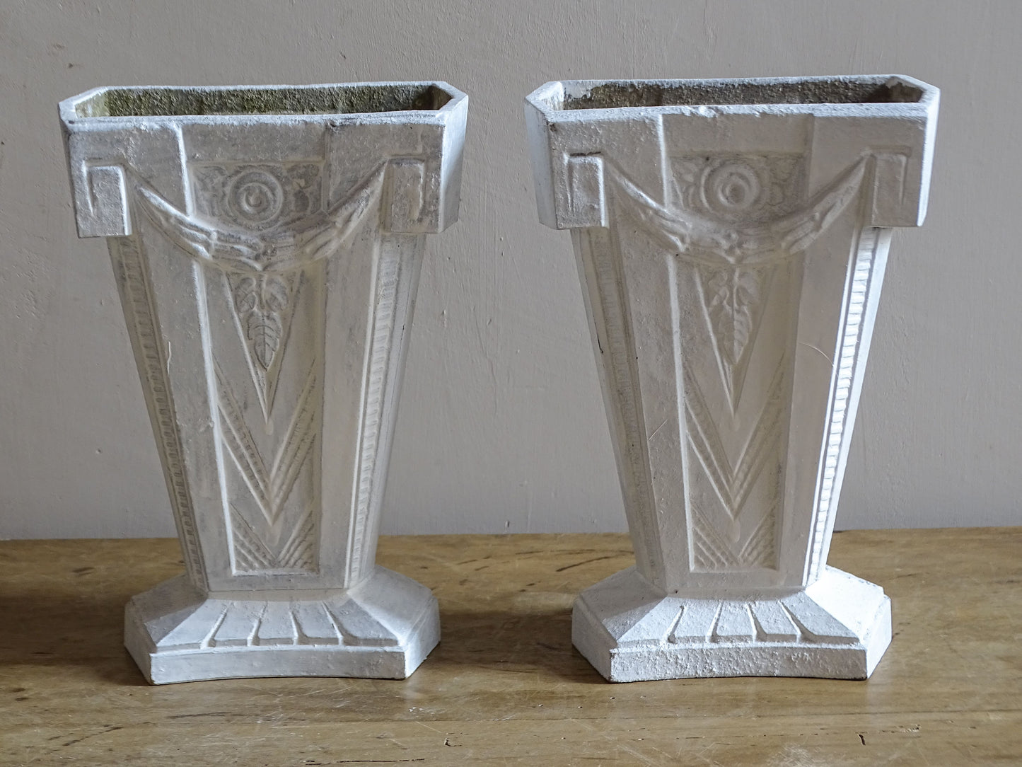 Vintage French cast aluminium vases with tapered forms, stepped bases and moulded Art Deco details.