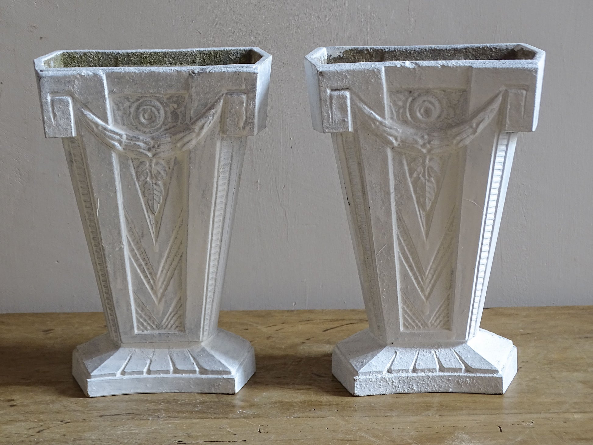 Vintage French cast aluminium vases with tapered forms, stepped bases and moulded Art Deco details.