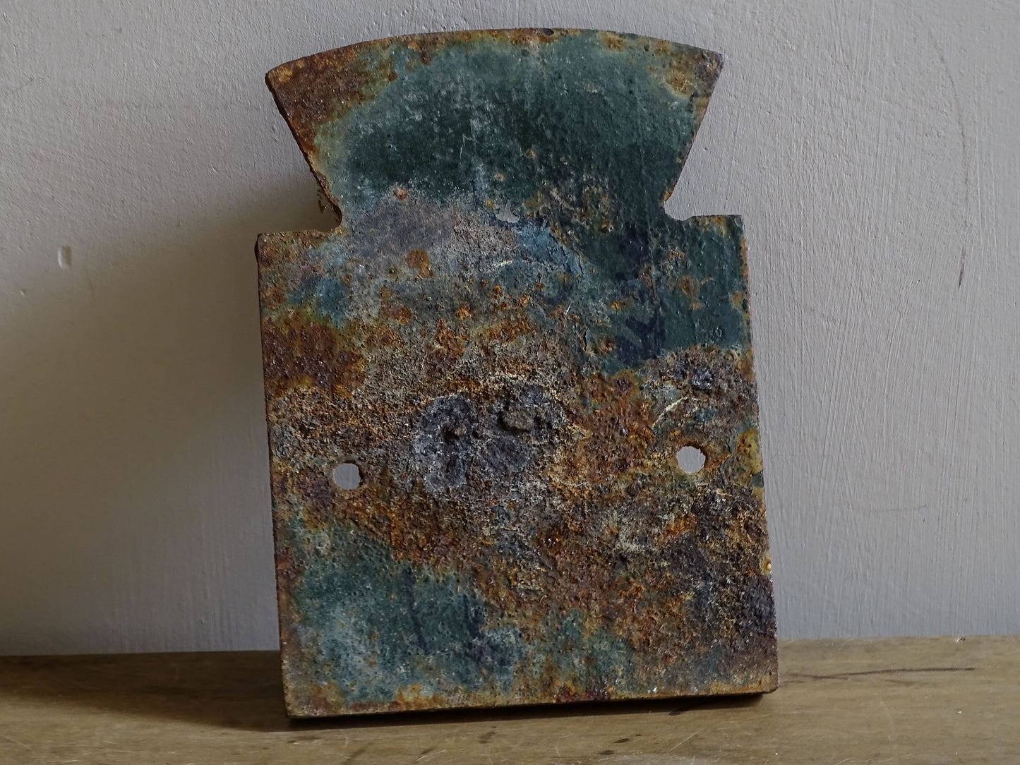 Reverse of a vintage French cast iron house number plaque from Beaumont-du-Périgord, showing the rough cast surface and fixing holes.