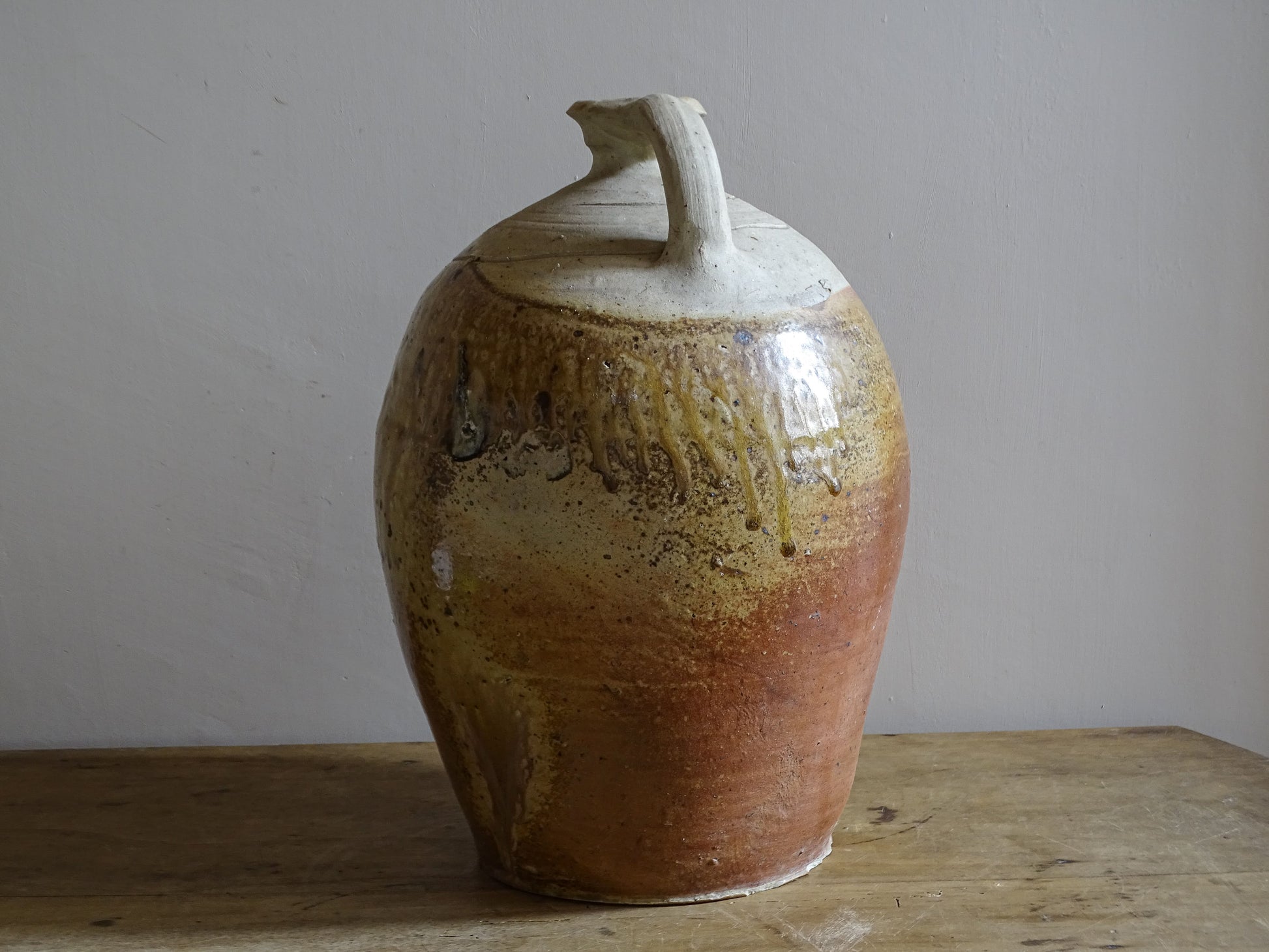 Glazed stoneware vessel with ochre brown and russet tones