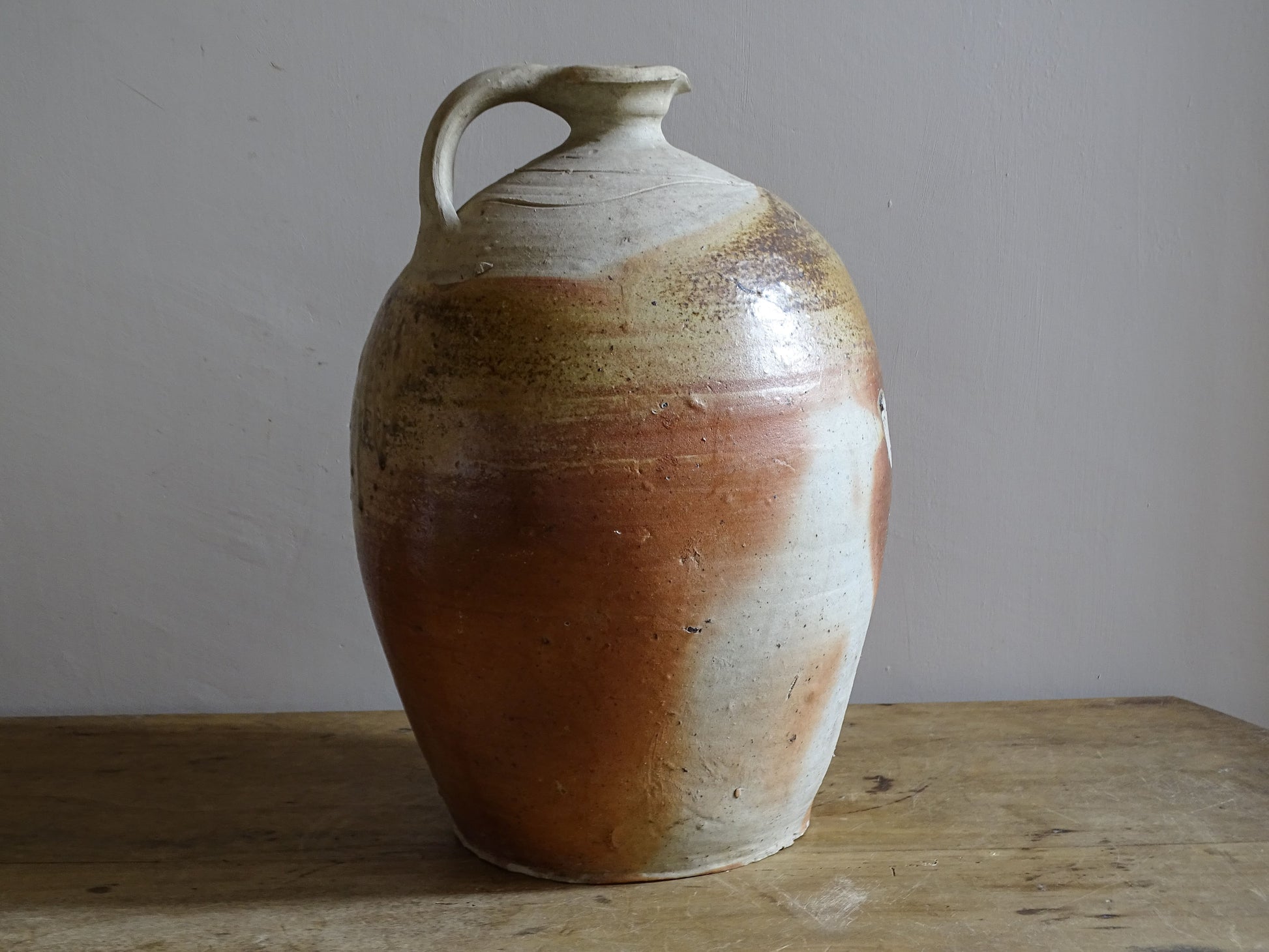 Traditional French stoneware cruche with firing marks and varied glaze