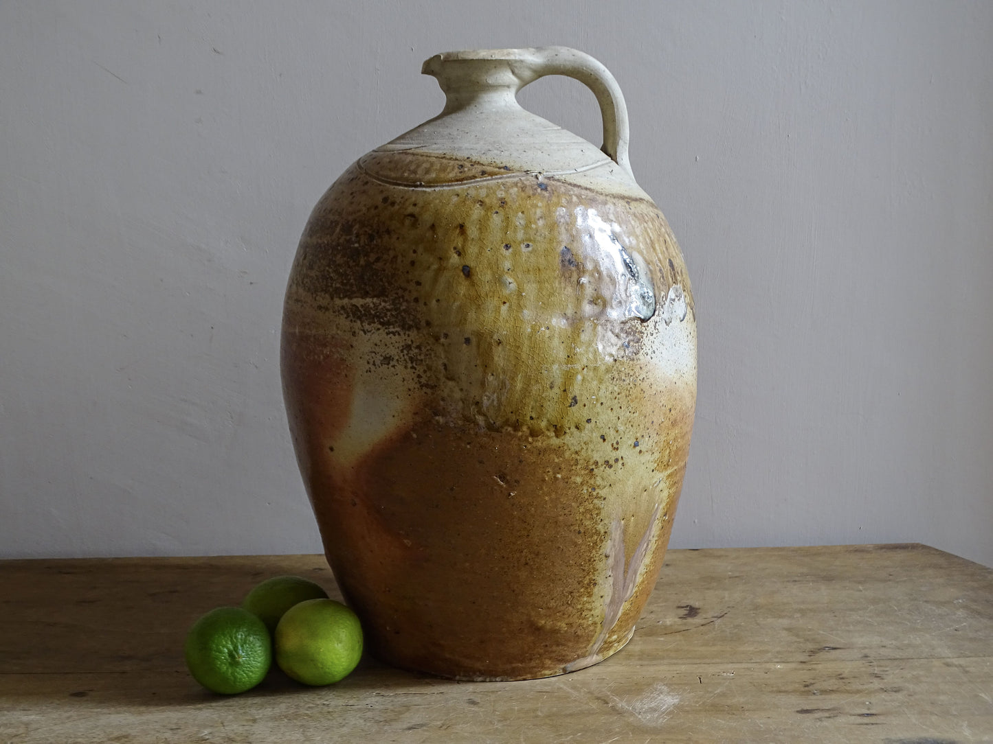 Large antique French stoneware jug or cruche with ochre and russet glaze