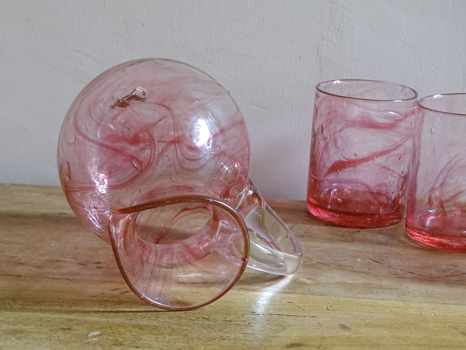 Hand-blown pale pink glassware set with pitcher and glasses
