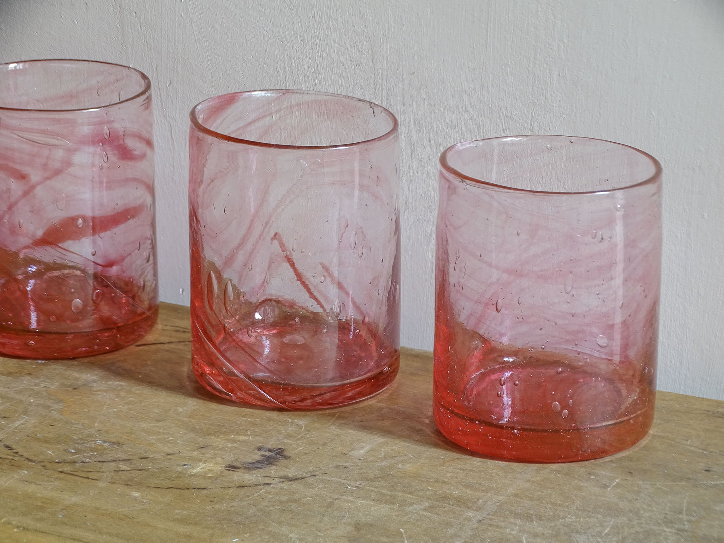 Set of six hand-blown pink glass tumblers with individual variations