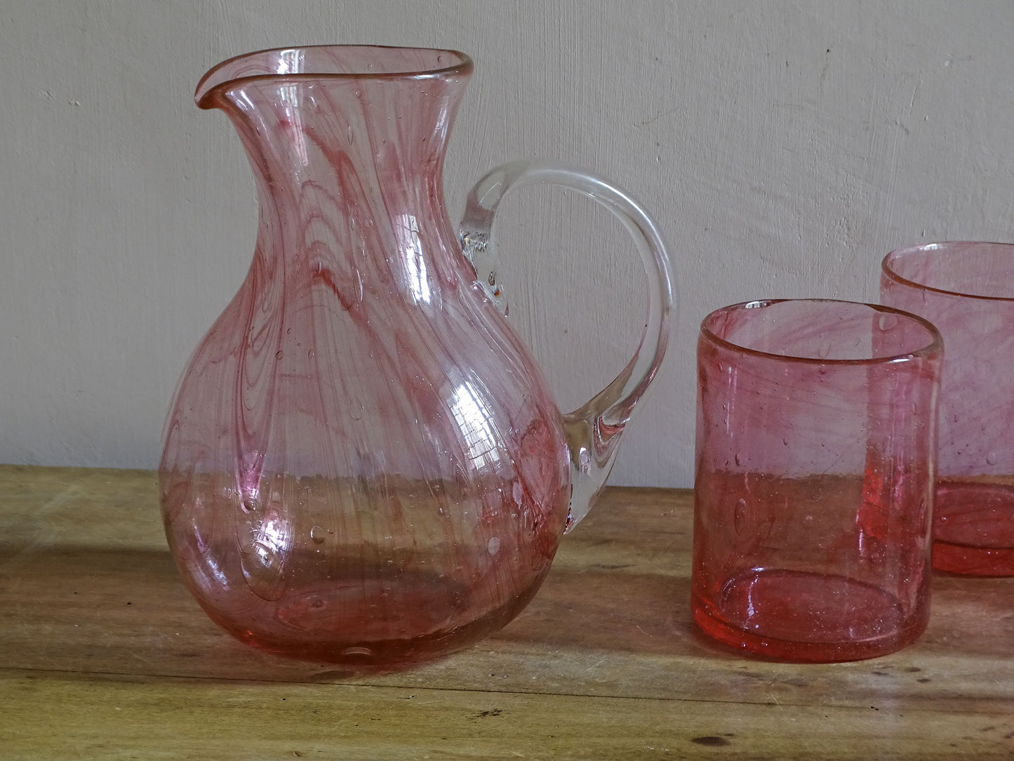 Vintage pink glass pitcher and six matching drinking glasses