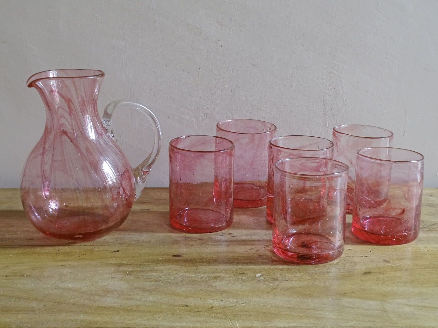 Complete seven-piece hand-blown pink glass drinking set