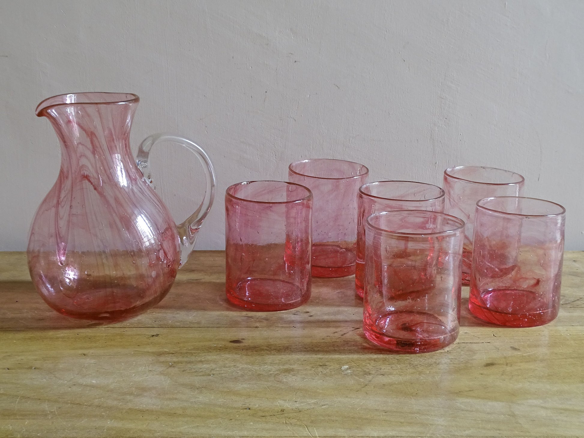 Complete seven-piece hand-blown pink glass drinking set