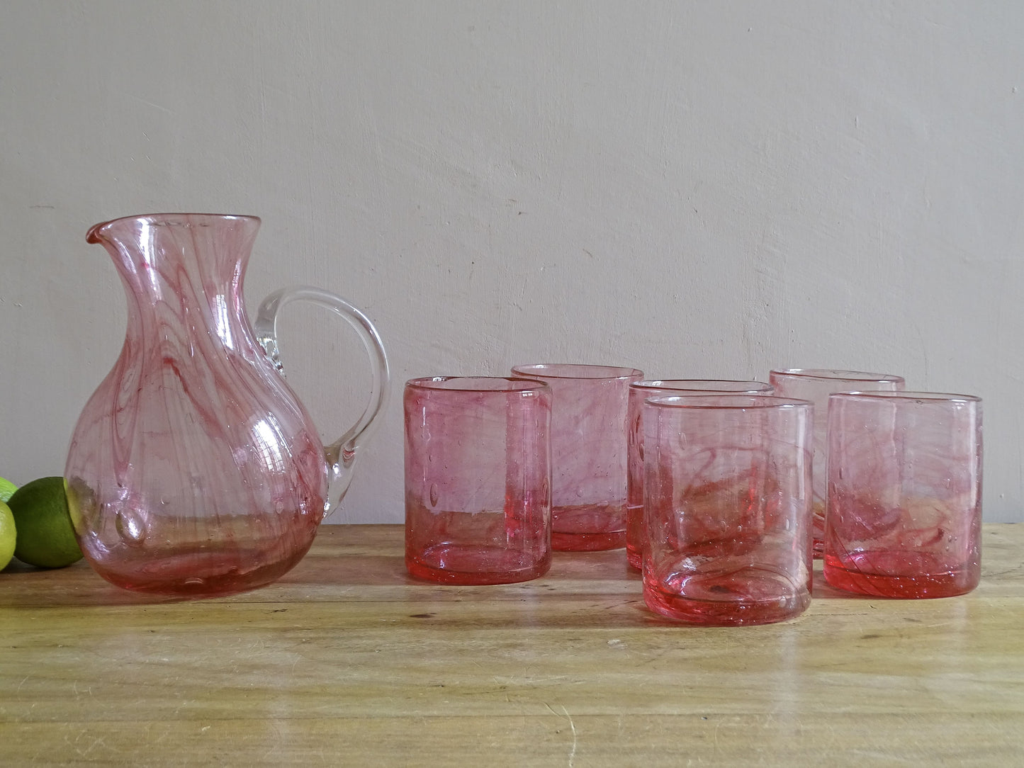 Vintage hand-blown pink glass pitcher with six matching tumblers