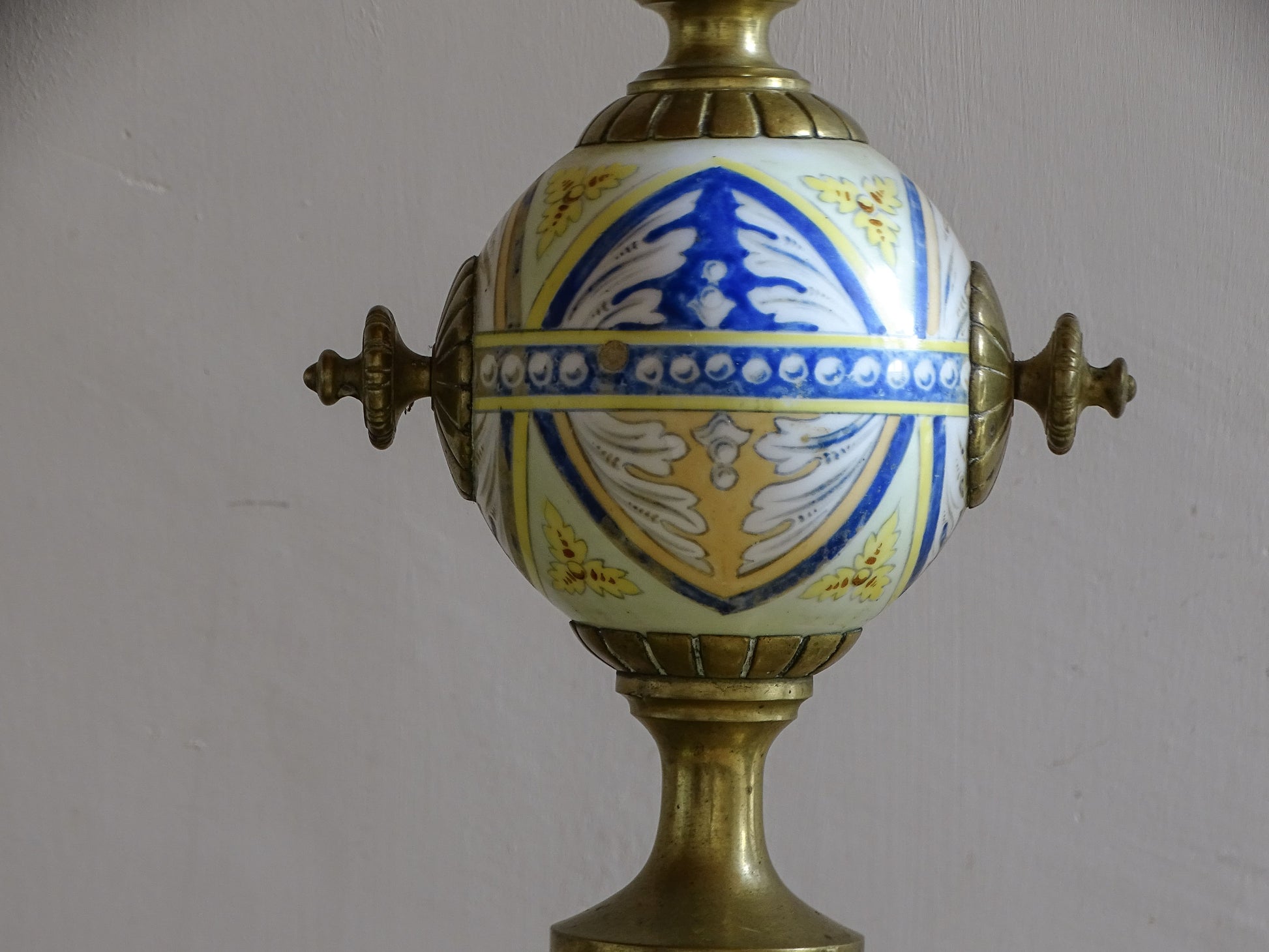 Antique French fireplace set with sculptural brasswork and hand-painted faience details
