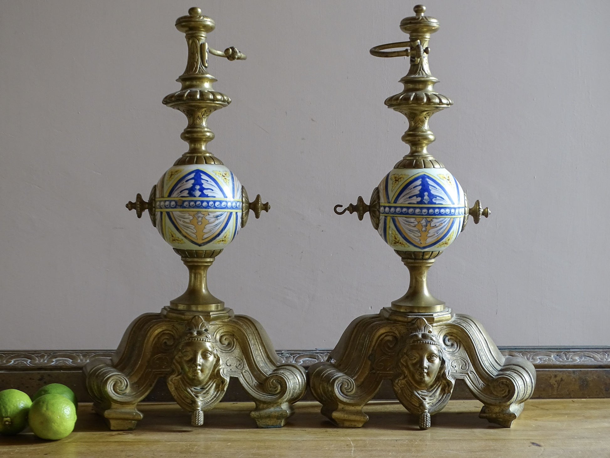 French Neo-Renaissance brass fireplace chenets with hand-painted ceramic globes and matching fender