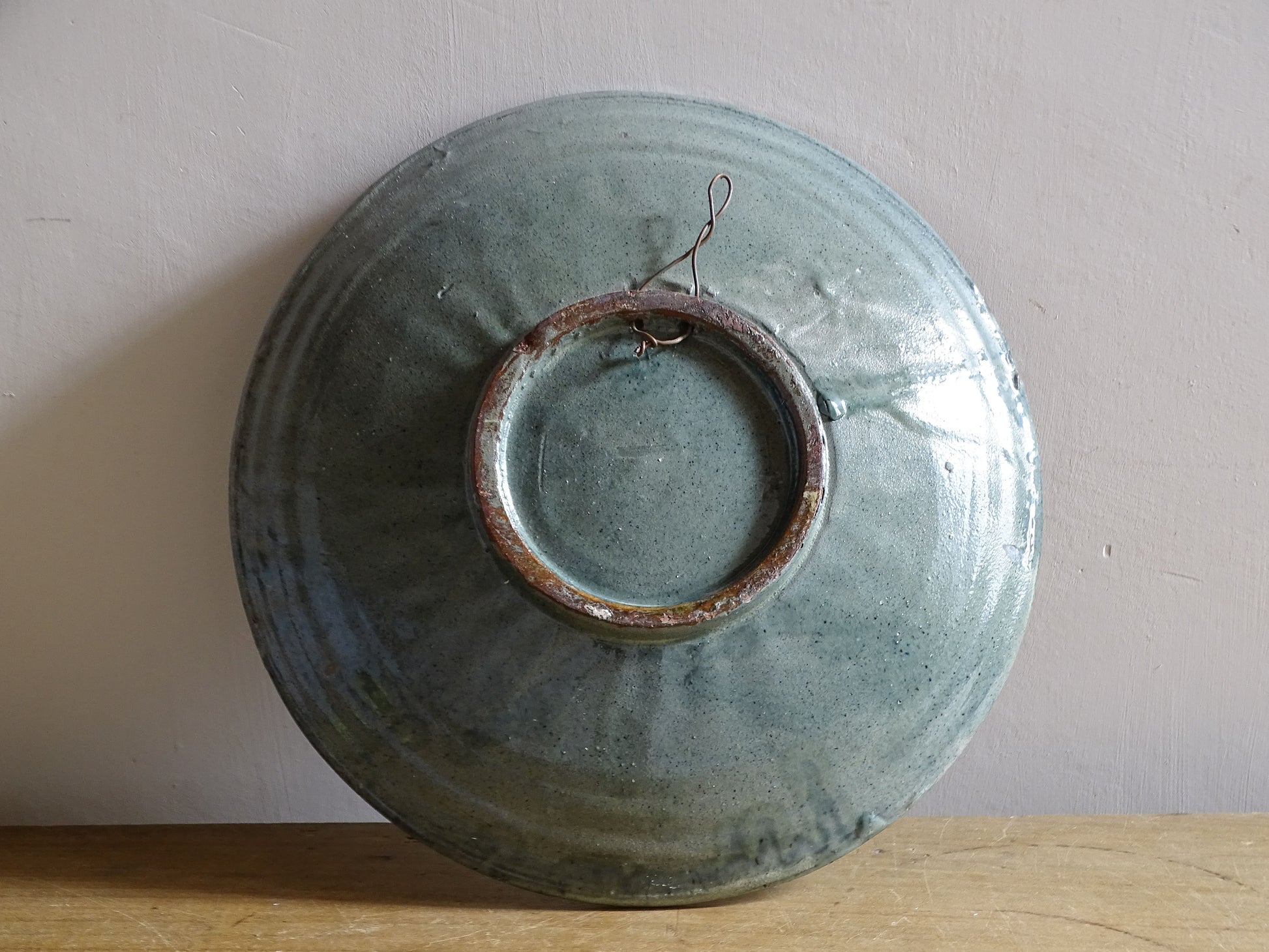 Glazed terracotta Spanish wall plate with stylised fish, seaweed and starfish
