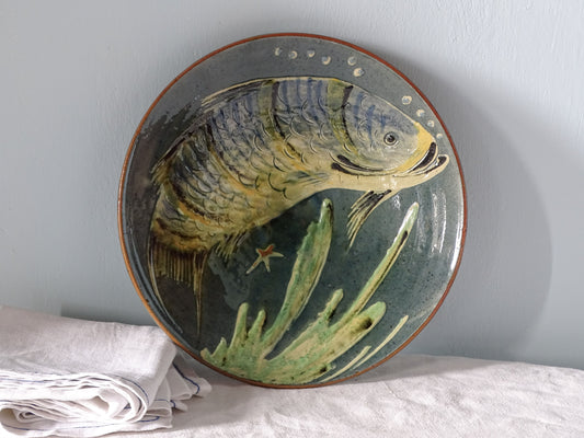 Spanish vintage ceramic plate with fish design, pictured with antique linen