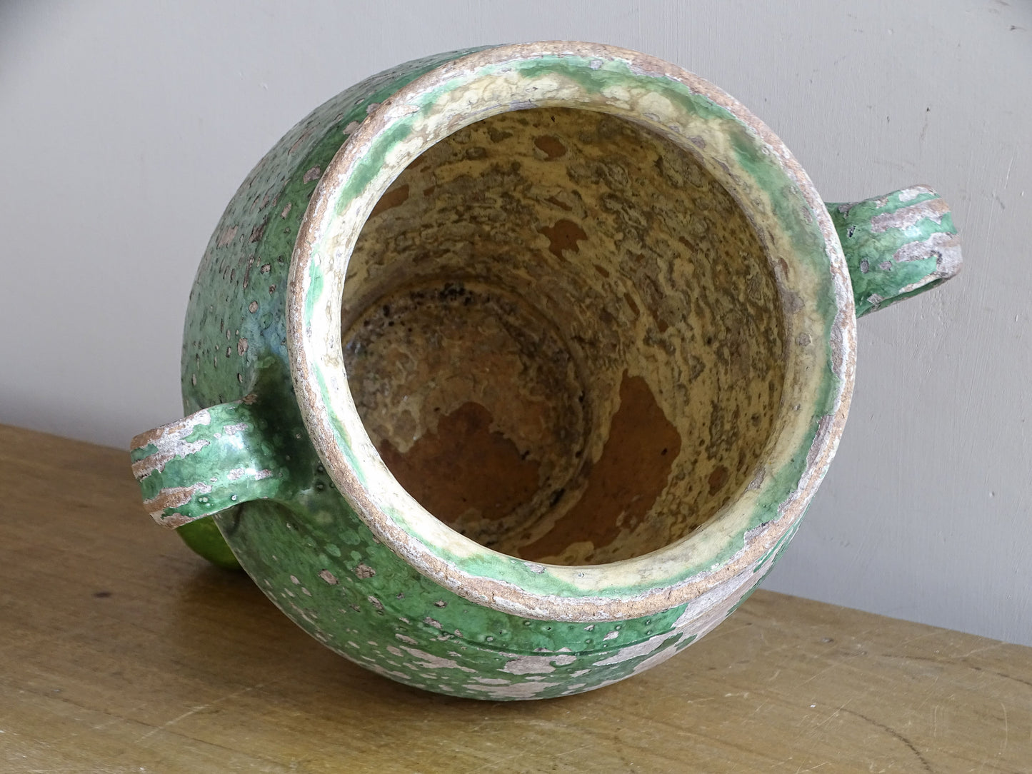 Antique French confit pot with green exterior and pale yellow interior glaze