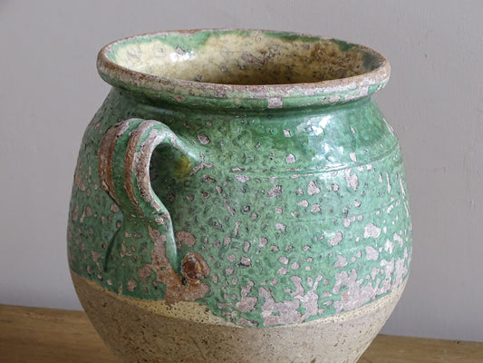 Old French earthenware pot with worn green glaze