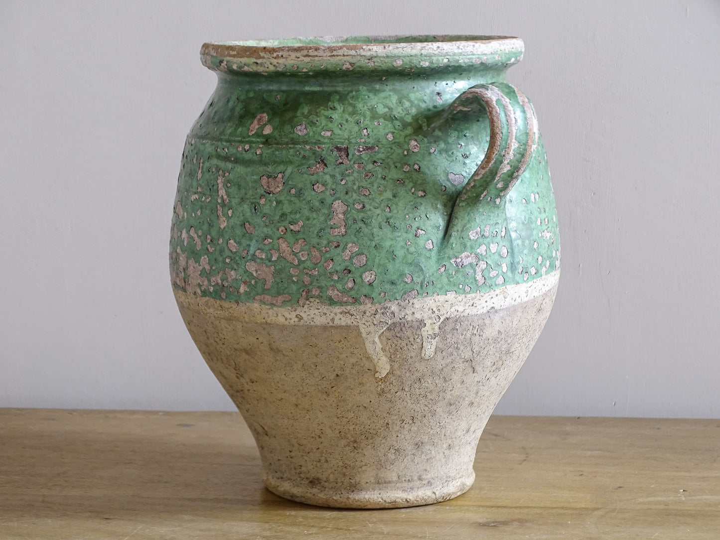 Vintage French pottery with mottled green glaze and exposed clay