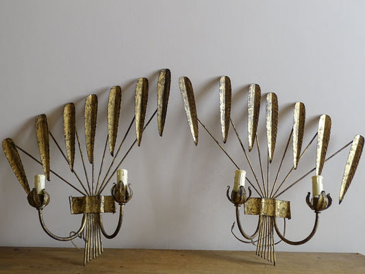Pair of Spanish mid-century gilt metal wall lights with radiating leaf design and twin candle arms