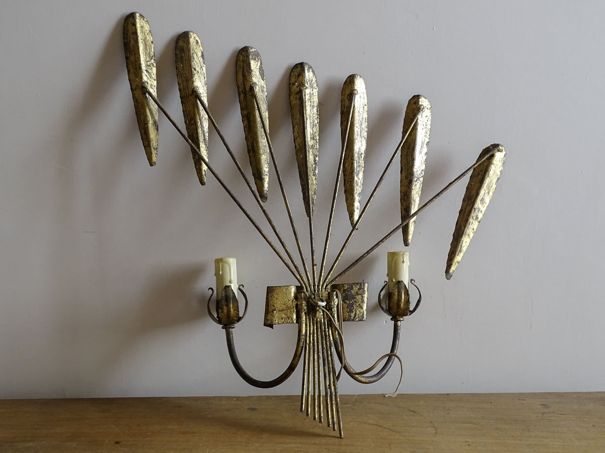Spanish mid-century gilt metal wall light with broad fan of radiating leaves and two candle arms