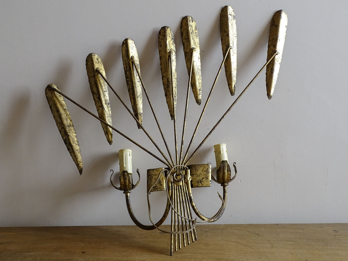 Spanish mid-century gilt metal wall light with broad fan of radiating leaves and two candle arms