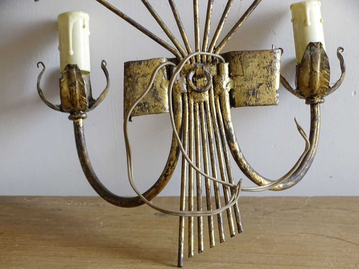 Spanish mid-century gilt metal wall light with broad fan of radiating leaves and two candle arms