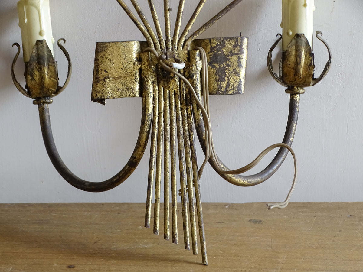 Spanish mid-century gilt metal wall light with broad fan of radiating leaves and two candle arms