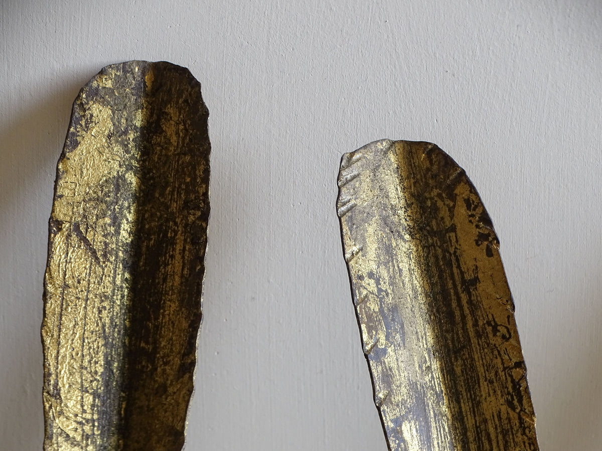 Detail of the textured gilt metal leaf and distressed finish on a Spanish mid-century wall light
