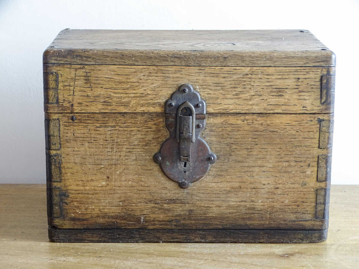 19th century French oak box with exposed finger joints and shaped metal clasp