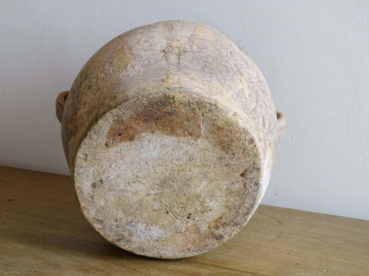 Base of antique French confit pot showing hand-thrown earthenware construction