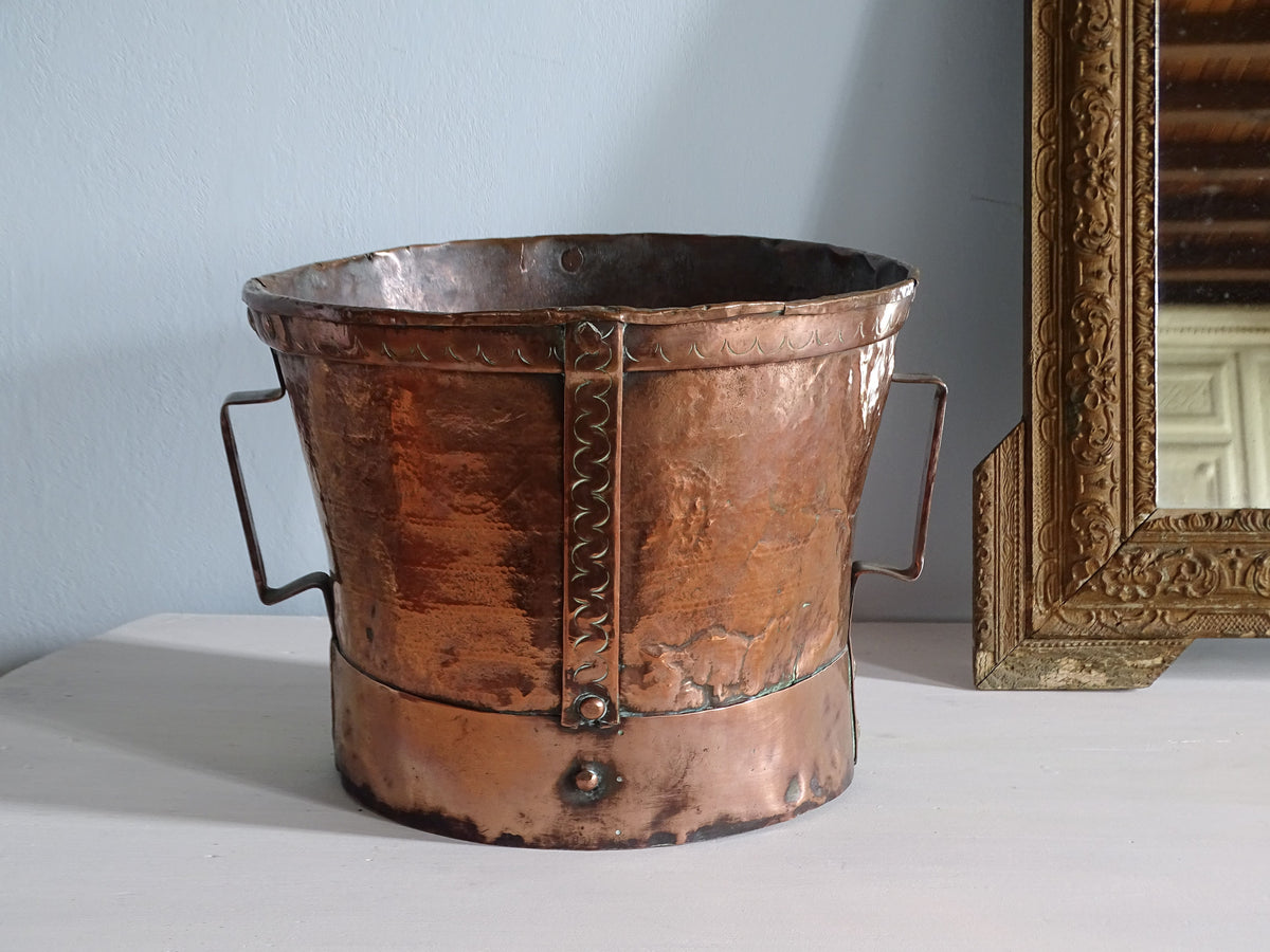 French antique copper vessel with handles, pictured with a gold mirror