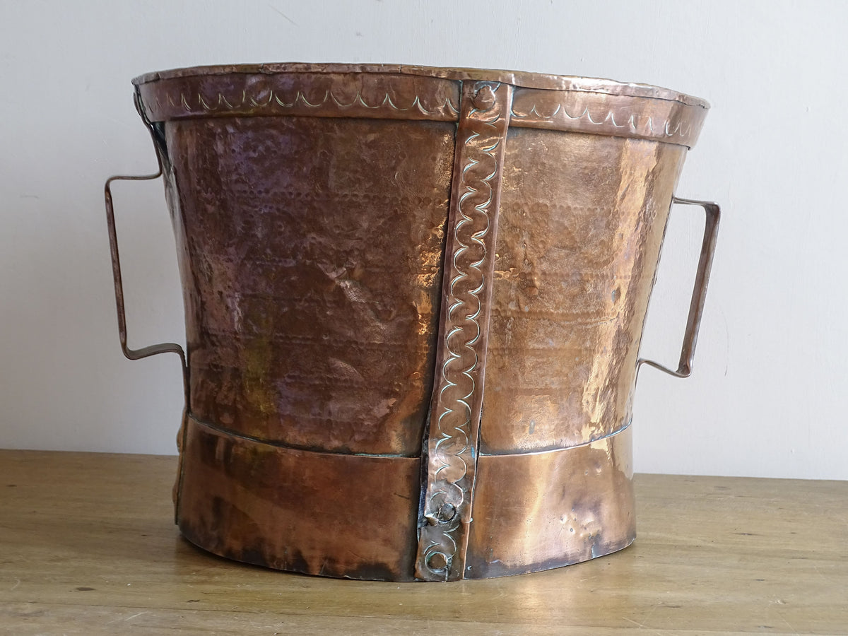 Antique French copper ferrat with twin side handles, hand-worked surface and decorative riveted straps