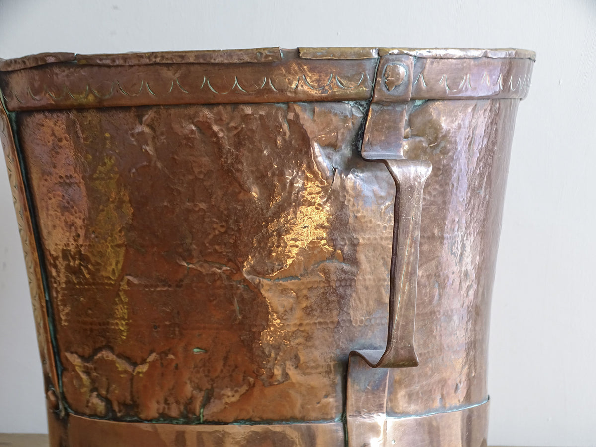 Detail of angular side handle and aged copper surface on an 18th century French vessel