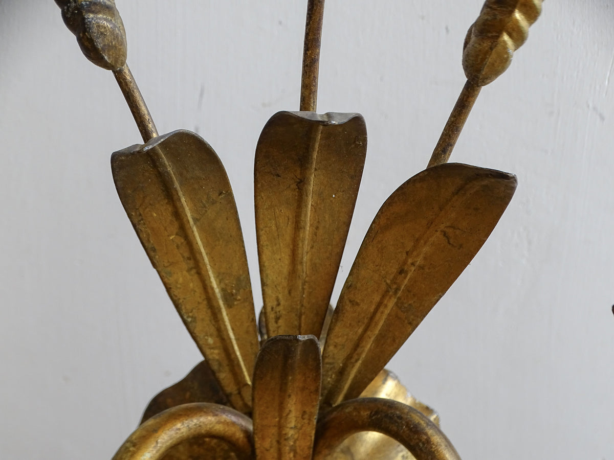 Close-up of pressed gilt metal leaves and wheat detail on mid-century French wall light