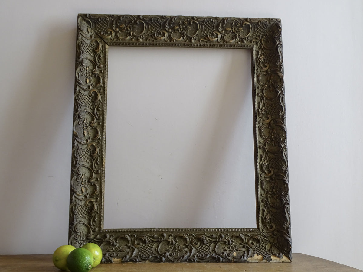 French antique ornate frame in 19th-century Louis XV style with floral scrollwork and aged gilt finish
