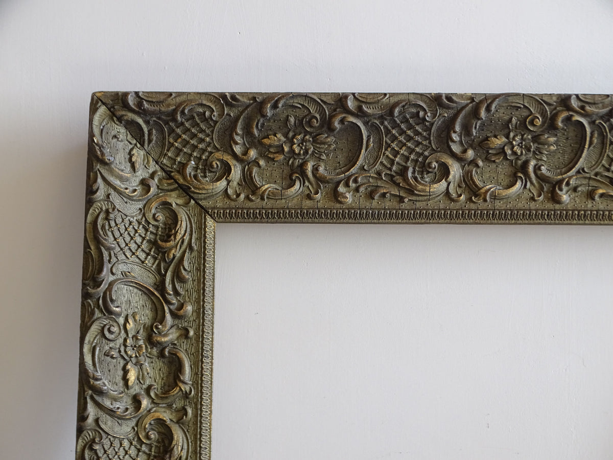 Upper left corner of French antique frame with scrolling foliage, flowers and trellis decoration