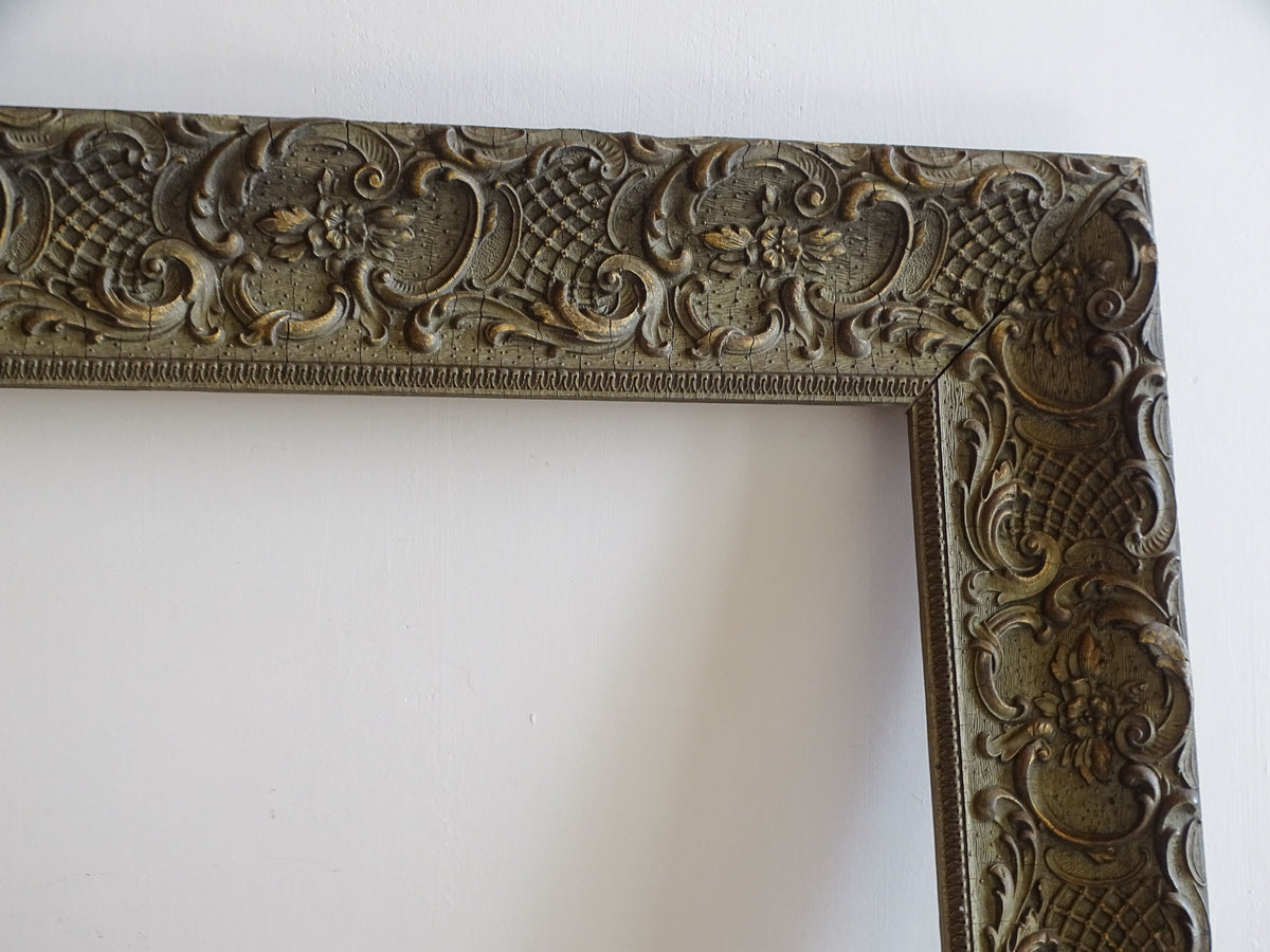 Upper right corner detail of 19th-century French ornate frame with moulded floral and rococo decoration