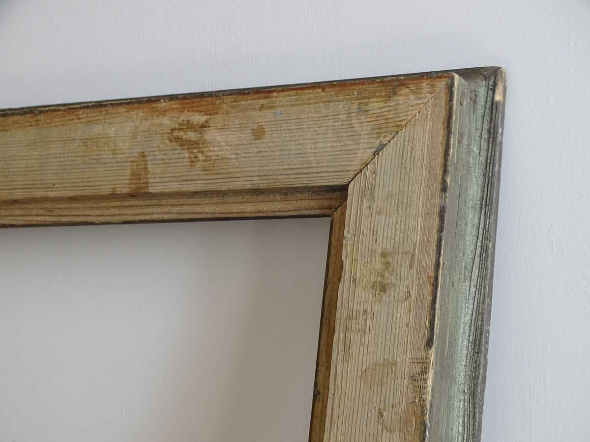 Back corner detail of antique French wooden frame showing mitred construction and aged wood