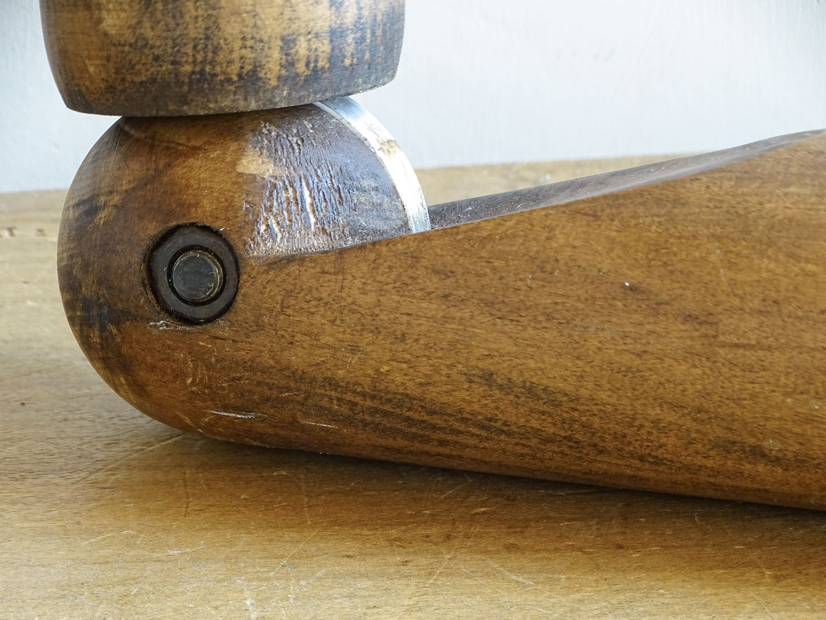 Close-up of the elbow joint on a mid-century articulated wooden mannequin arm