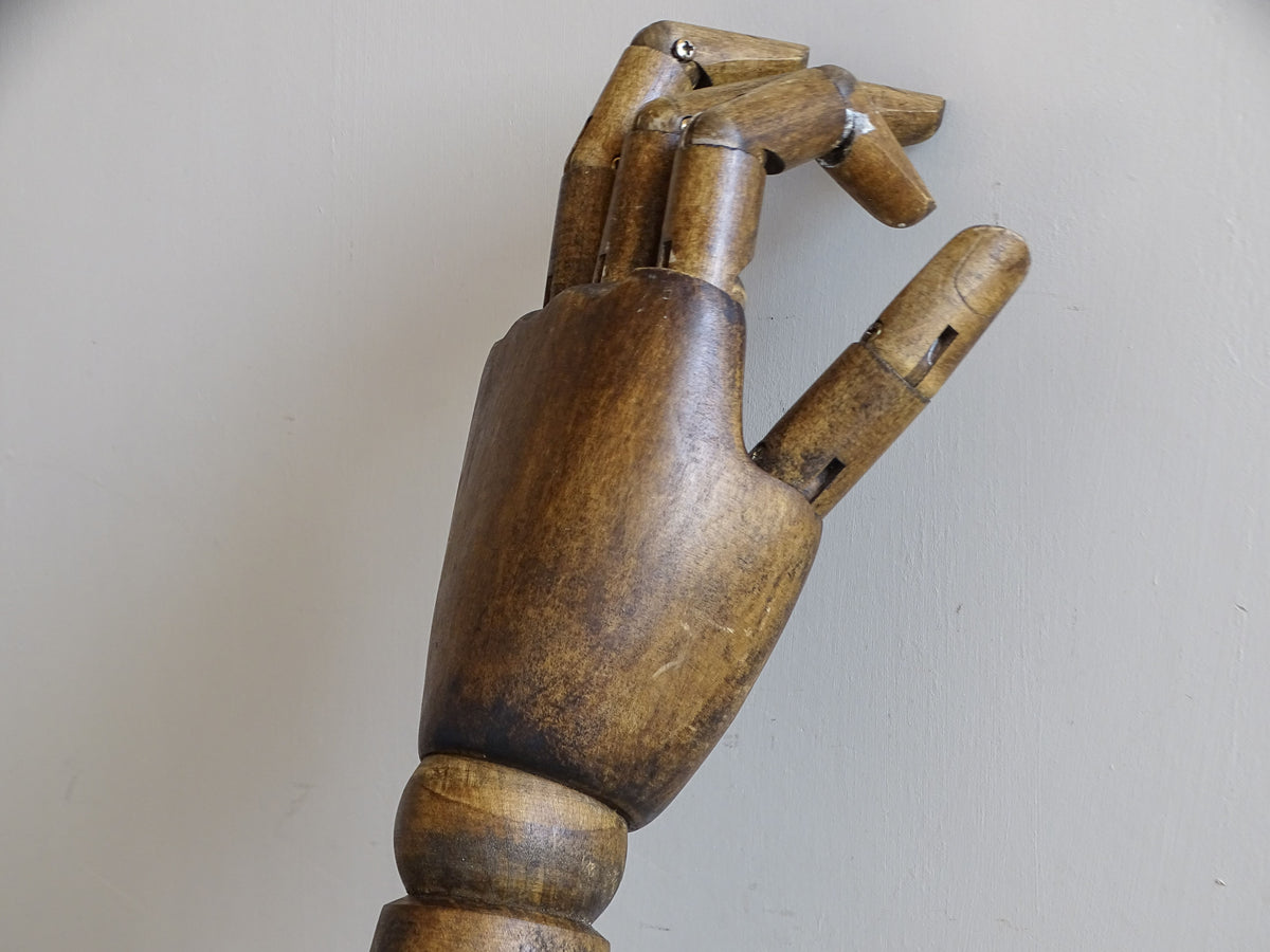Side view of a vintage articulated wooden mannequin hand with jointed wooden fingers