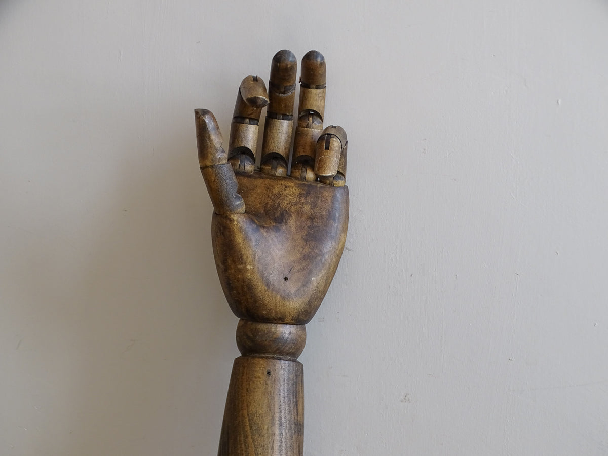 mid-century articulated wooden mannequin arm displayed upright with jointed hand
