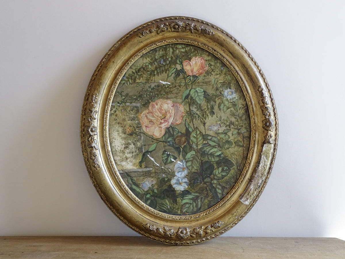 French antique floral painting on ceramic in an ornate gilt oval frame, 19th century