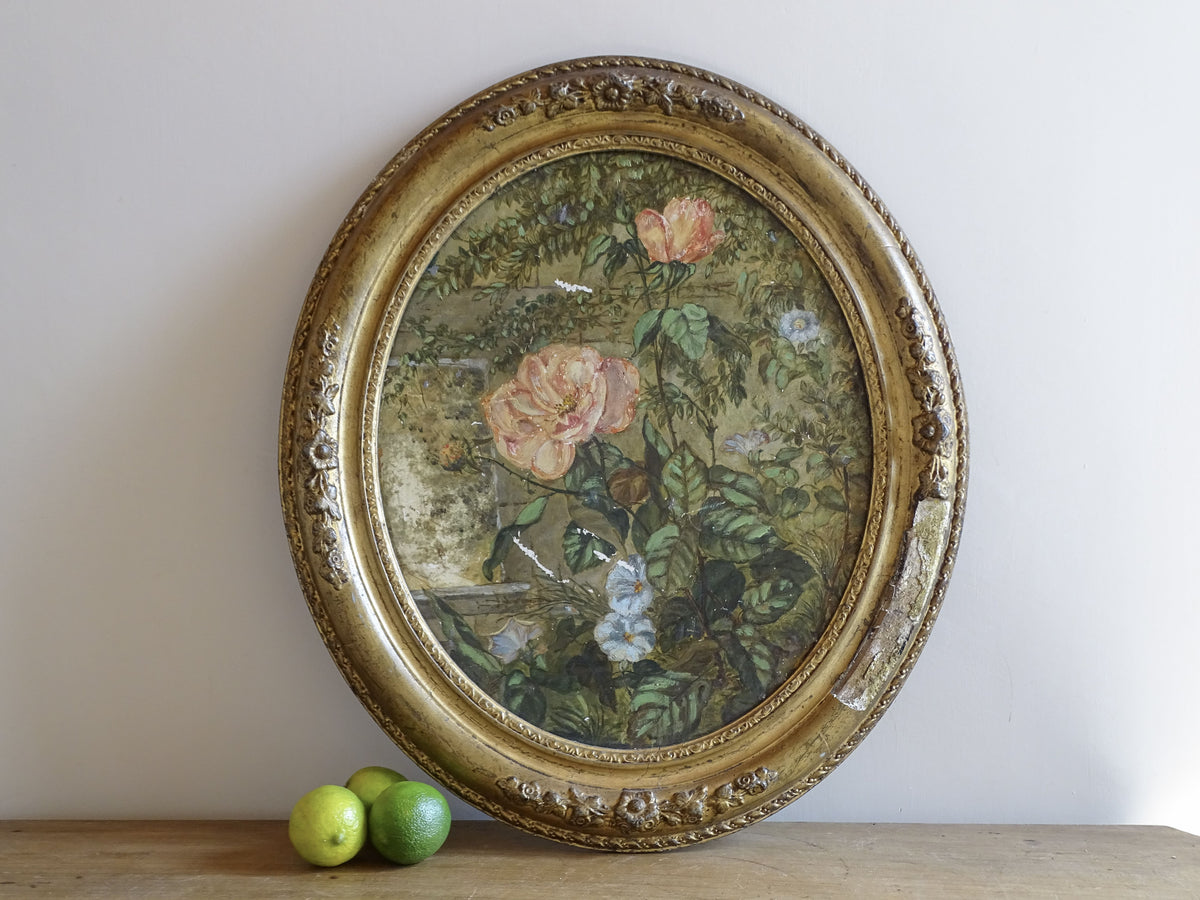 19th-century French ceramic painting of pink roses and blue flowers in a gilt oval frame