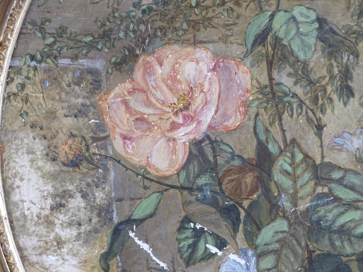 Detail of pink rose and blue flowers painted by hand on the antique ceramic plaque