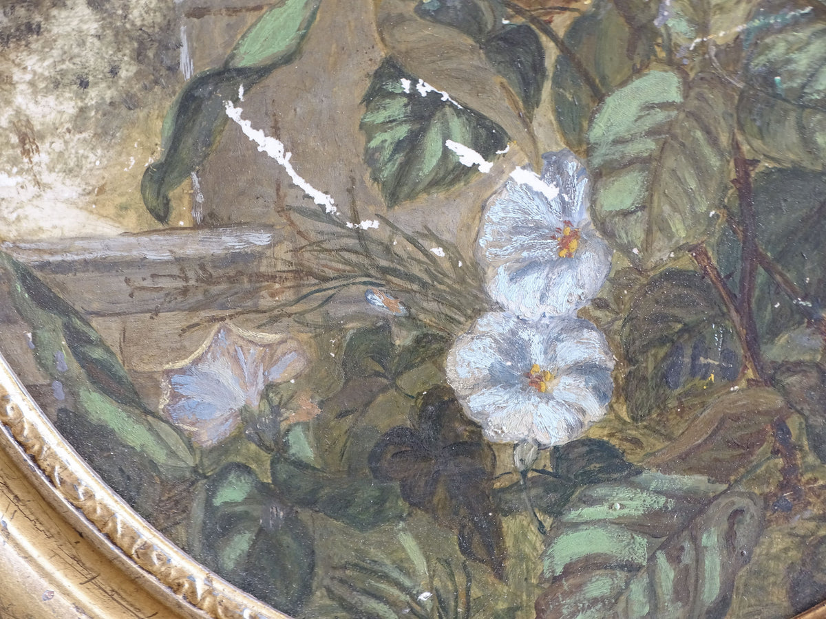 Close-up of blue flowers, green foliage and paint wear on the ceramic painting