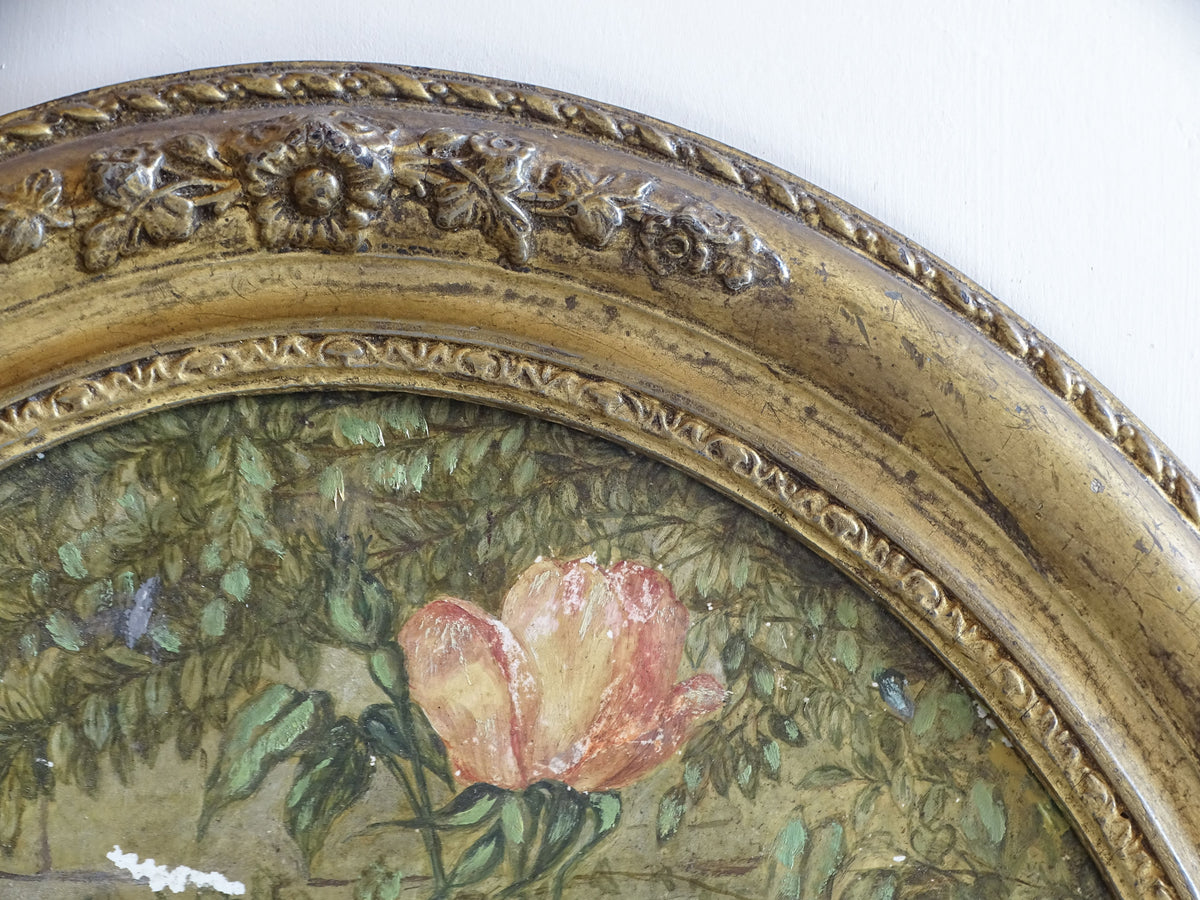 Ornate gilt frame with moulded floral decoration surrounding the antique ceramic painting