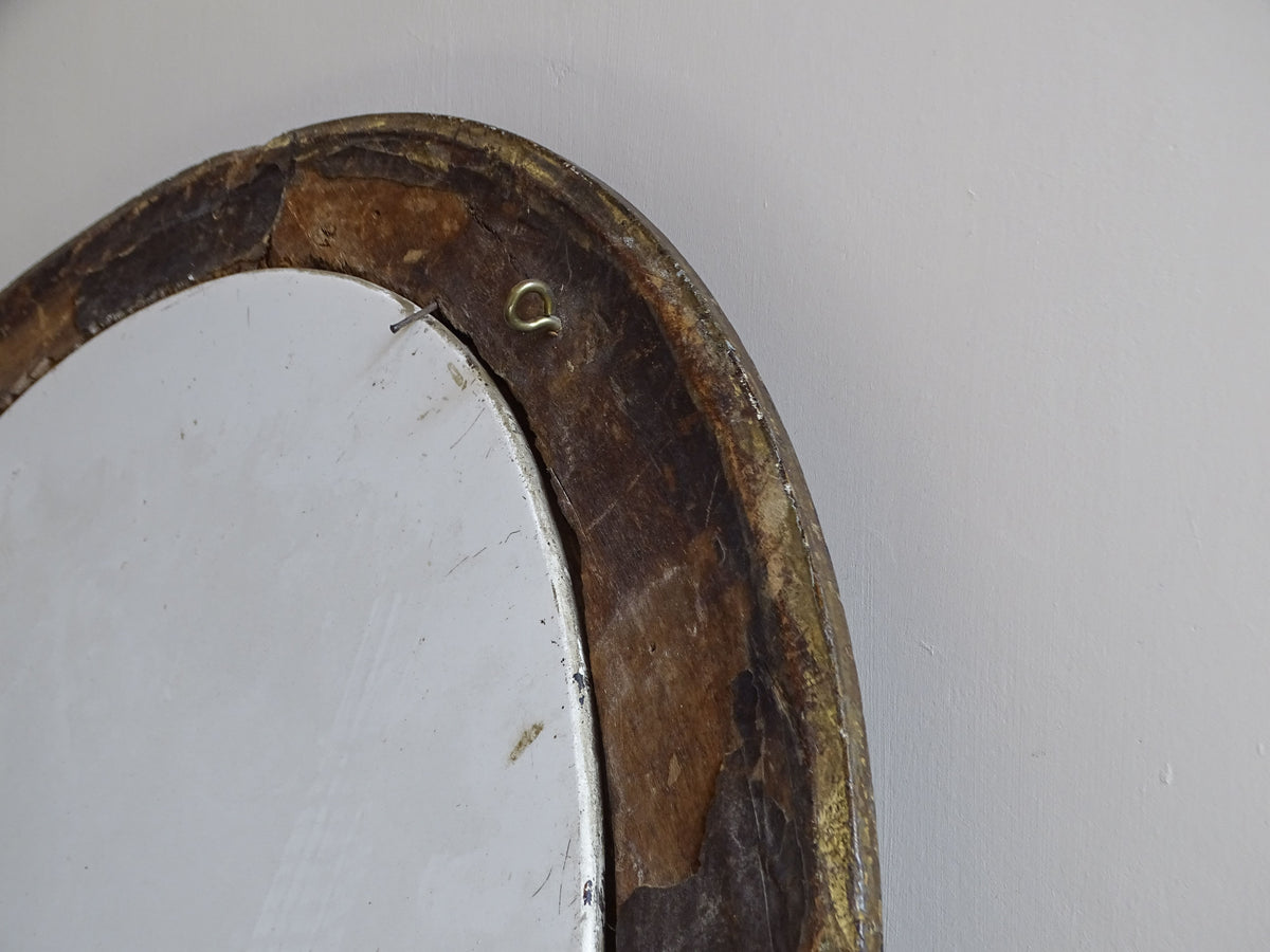 Reverse detail of antique oval gilt frame with ceramic plaque secured in place
