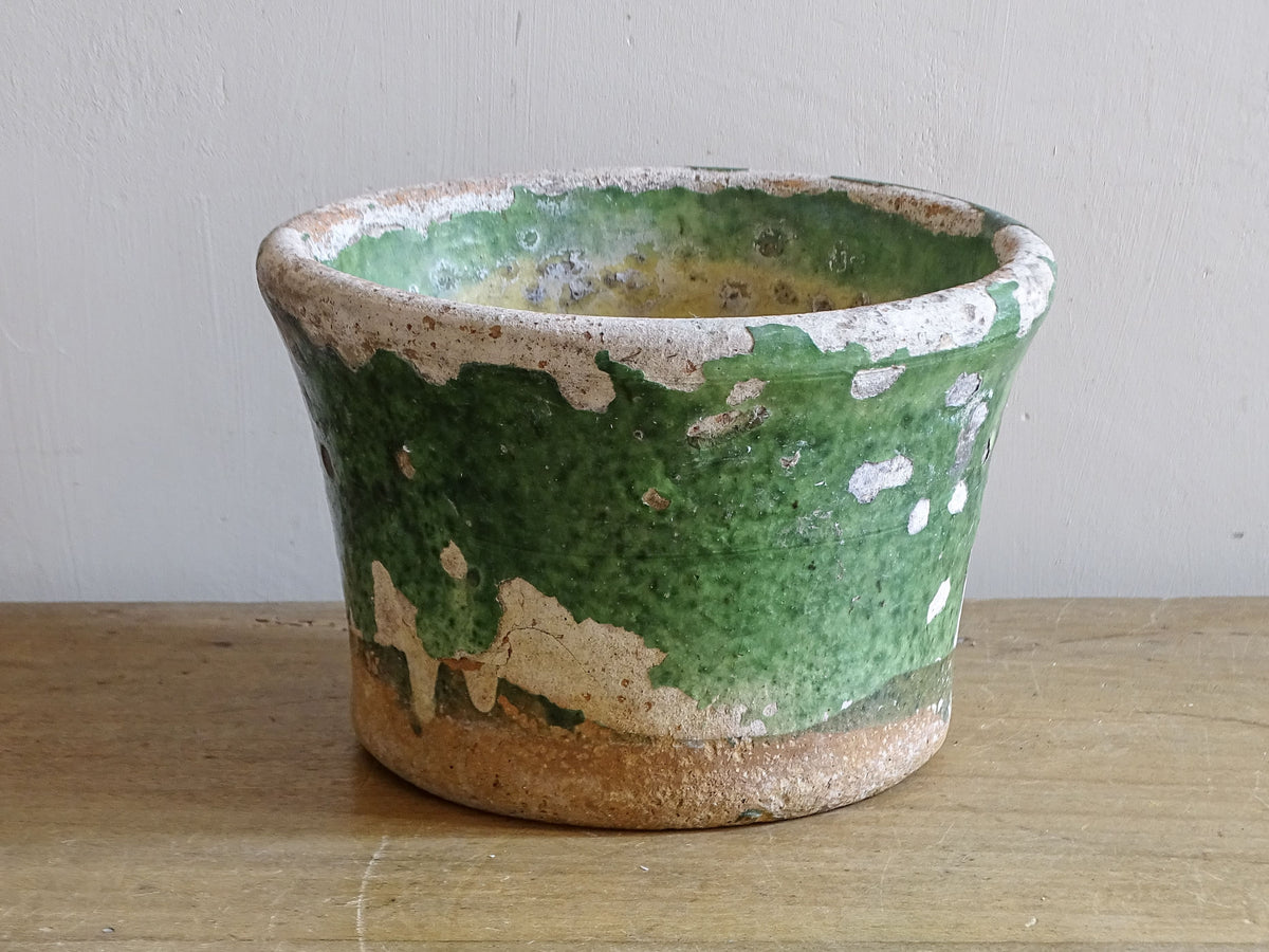 Small antique French green glazed pottery pot showing aged surface
