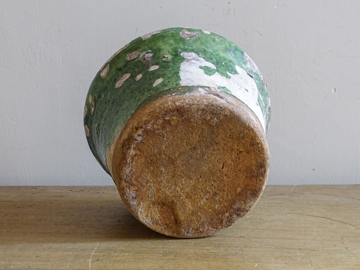 Antique French green glazed pot styled with fresh citrus fruit